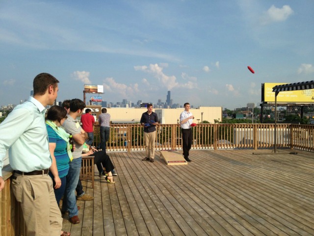 DMC employees play a friendly game of bags in the sun.