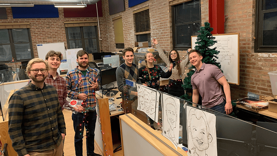 Team Members Hanging Christmas Lights on the Tree