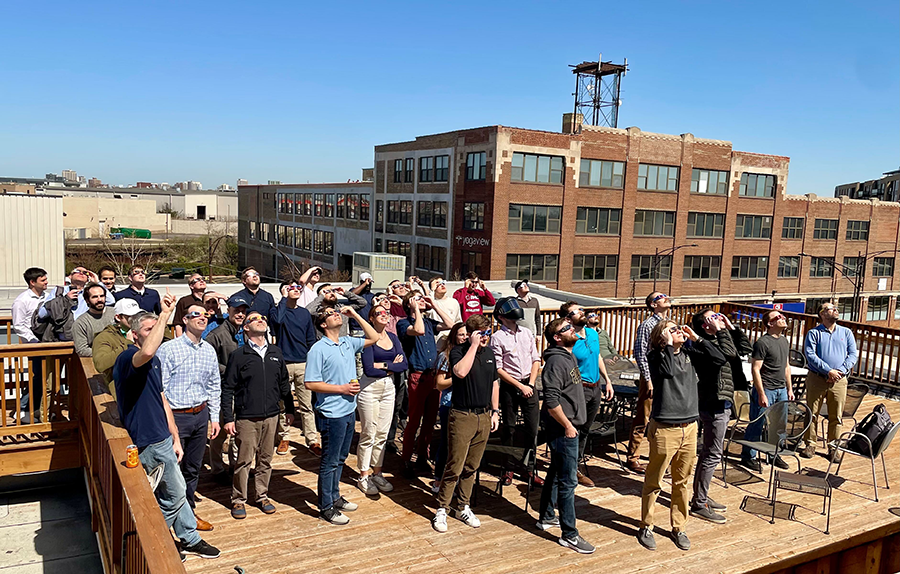 Chicago DMCers on the roof deck looking up at the Solar Eclipse