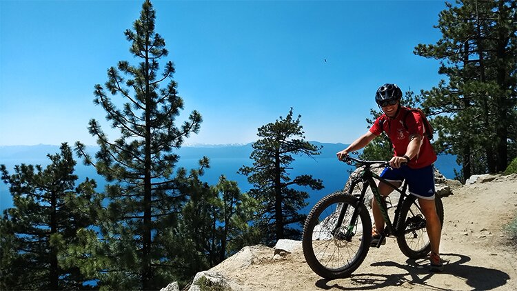 Photo of Andrew Crowley on a mountain bike on the Flume Trail.