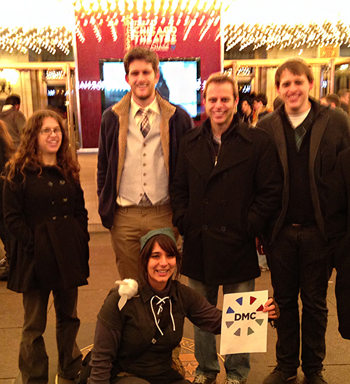 DMC employees pose outside of the Chicago Theater.