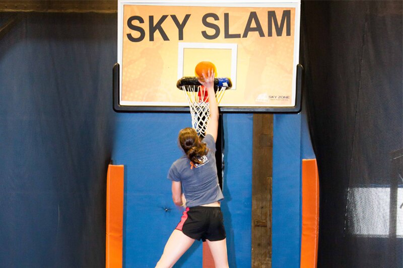 Systems Engineer Erin Meyer does a sweet slamdunk at SkyZone.