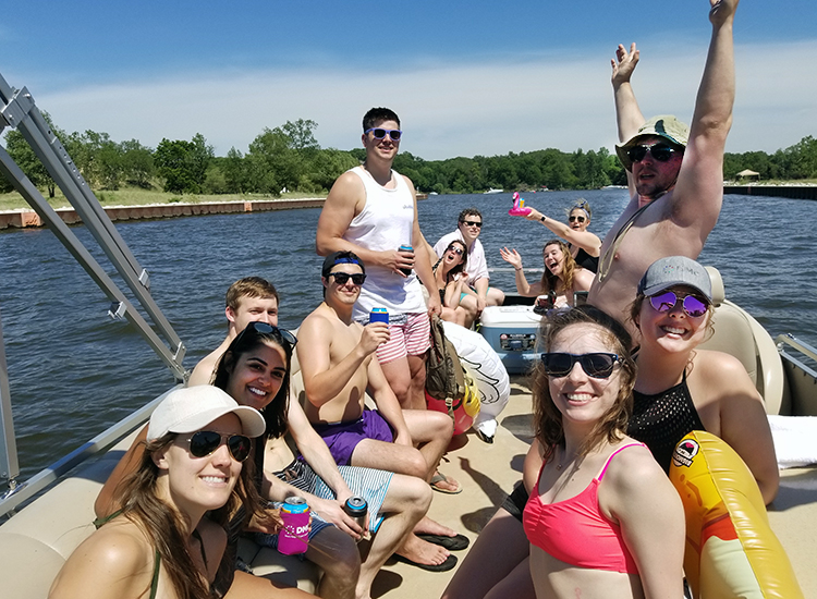 Photo of DMC employees and friends on a pontoon near Lake Michigan.