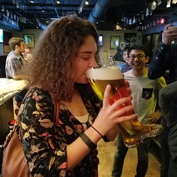 Cecilia Brookshire drinks from a glass boot at Bar Munich in Midtown Houston during the Houston YOE Peddle Pub Party.