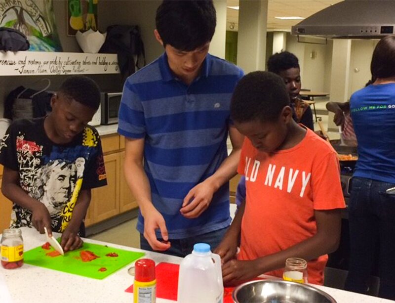 Photo of kids chopping veggies at a Healthy Start event with DMC Cares and Chicago Cares.