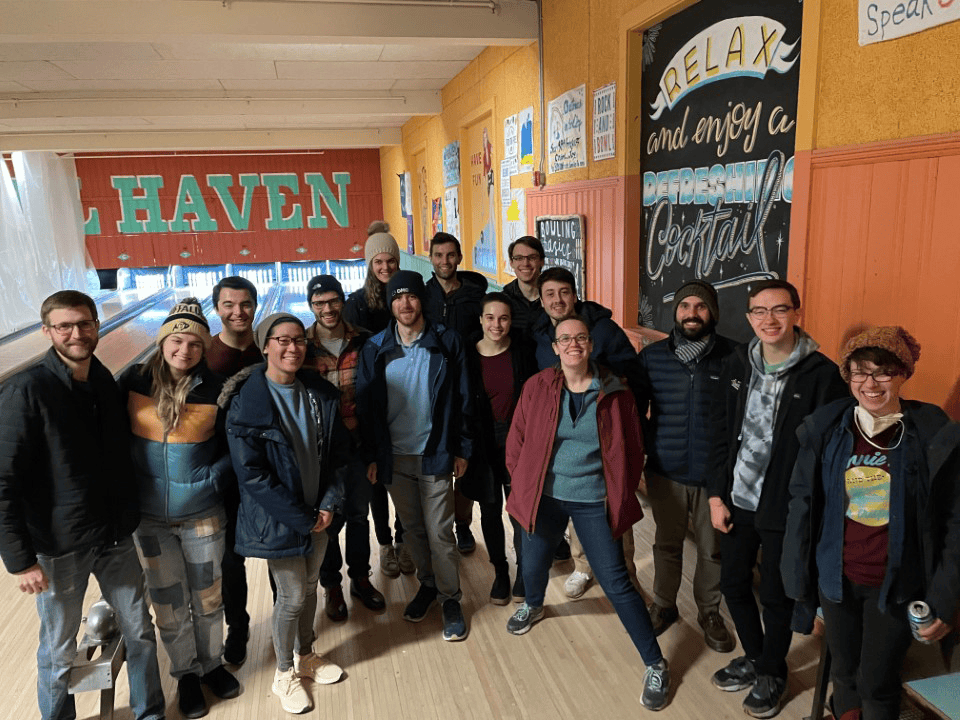 DMC's Boston team poses for a photo at a bowling alley.