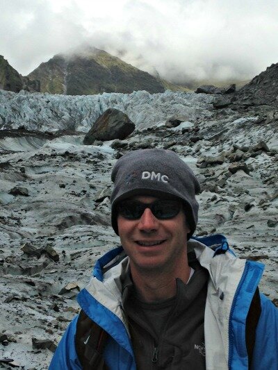 DMC client wears DMC gear while mountain climbing.