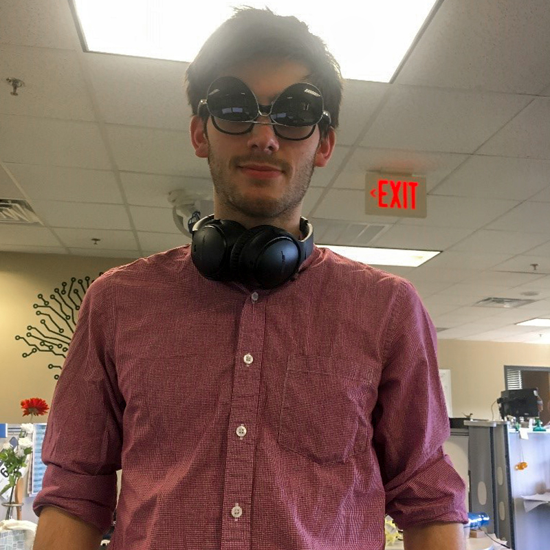 Photo of Eric wearing two pairs of glasses.