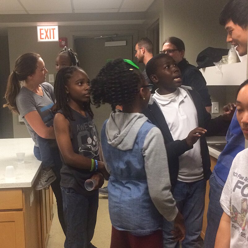 Photo of DMC Cares participants hanging out with the kids at the Healthy Start event.