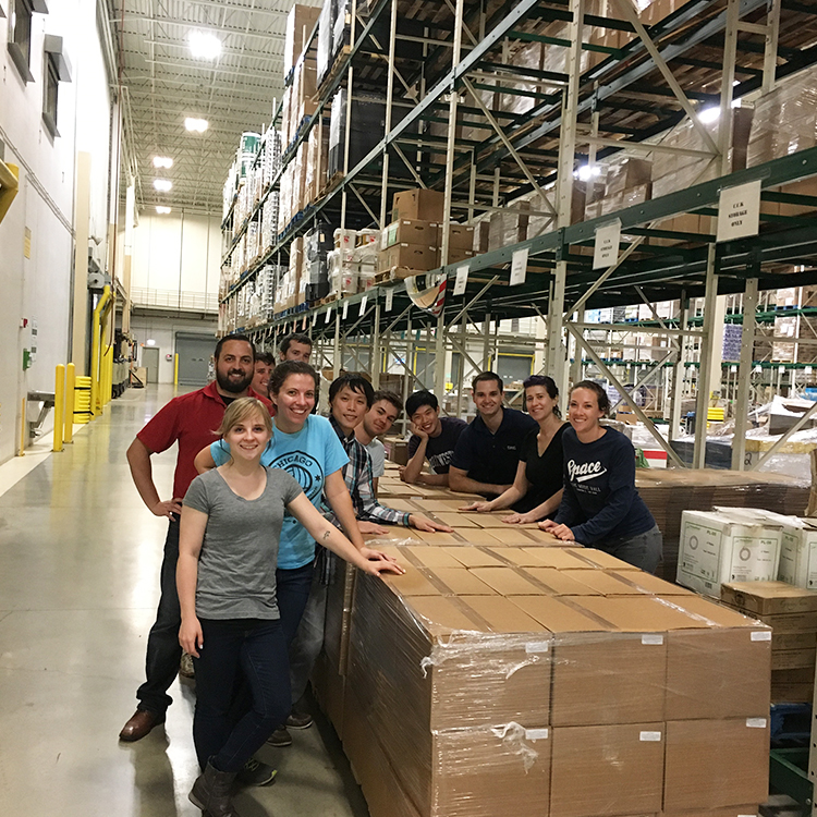 Group photo of DMC employees who helped package food.