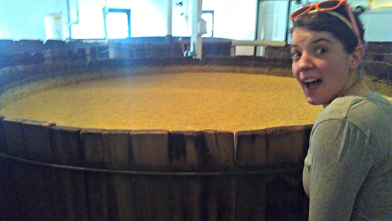 Courtney at the barrels of whiskey.