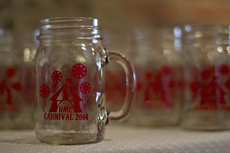 DMC Carnival mugs are on display.