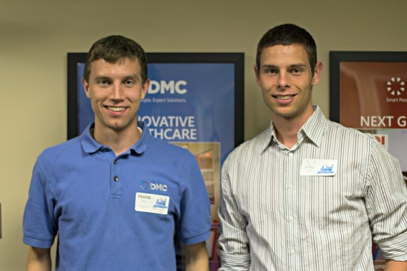 Two engineers from DMC smile for the camera.