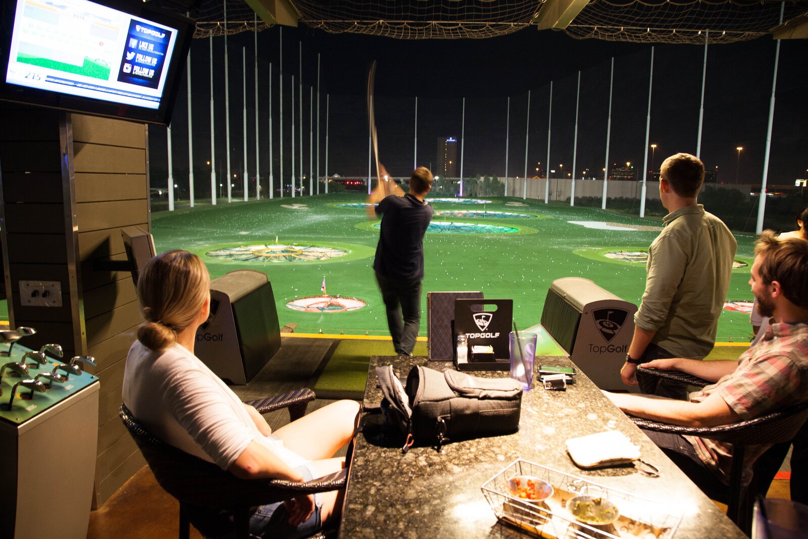 The DMC Houston team enjoys a round of Top Golf