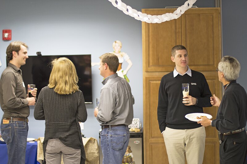 Guests mingle and enjoy food at DMC Boston.