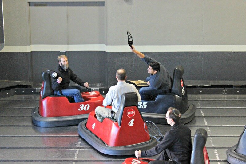 Accounting Assistant Chris Vasquez attempts to block a pass on the WhirlyBall court.