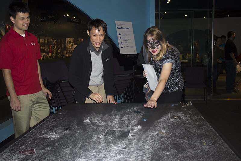 DMC employees playing "Cosmic Bowling" at the Adler Planetarium for a welcome party.