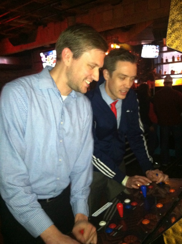 Jon Carson and Matt Puskala engage in friendly competition in the arcade.