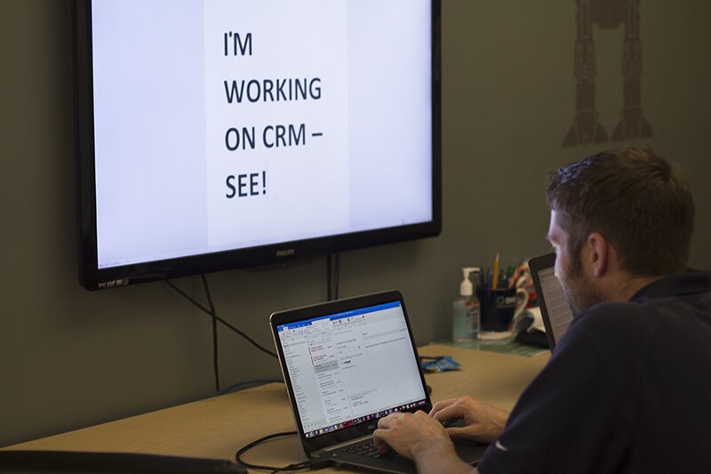 Senior Systems Consultant Tim Johnson works on upgrading DMC to Microsoft Dynamics CRM 2015