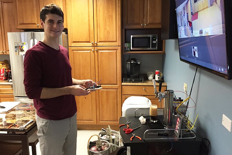 Otto working on automating a kegerator in the Denver office.