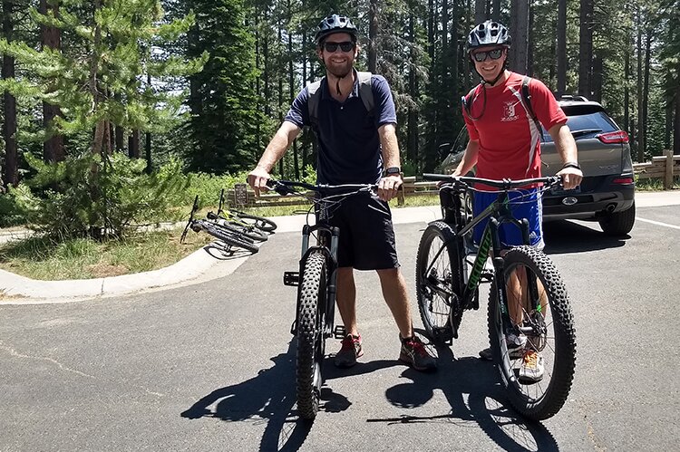 Photo of Leigh Matthews and Andrew Crowley with their mountain bikes.