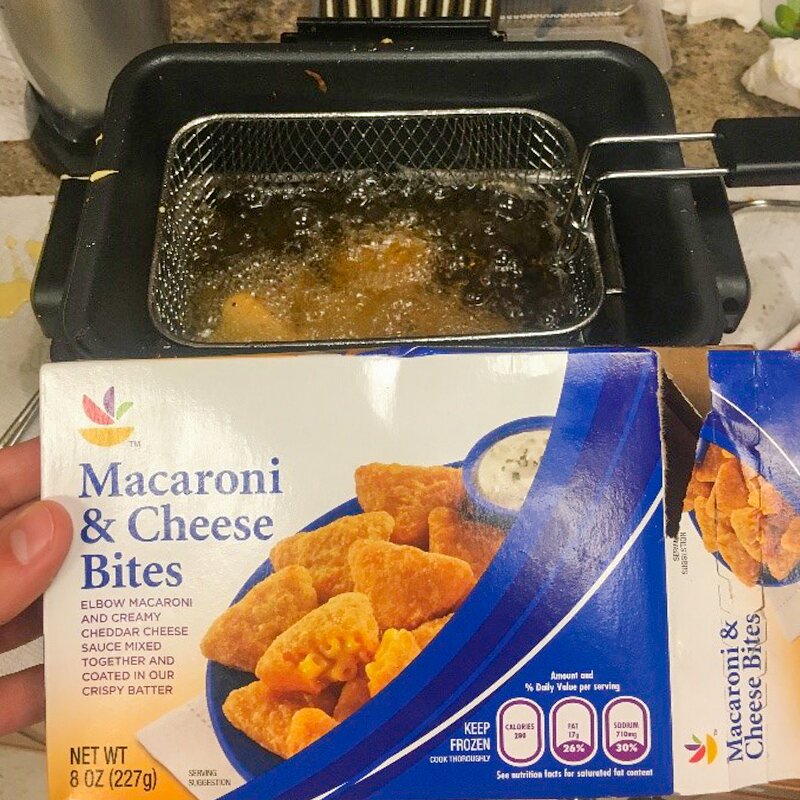 Photo of mac n cheese bites frying in the fryer.