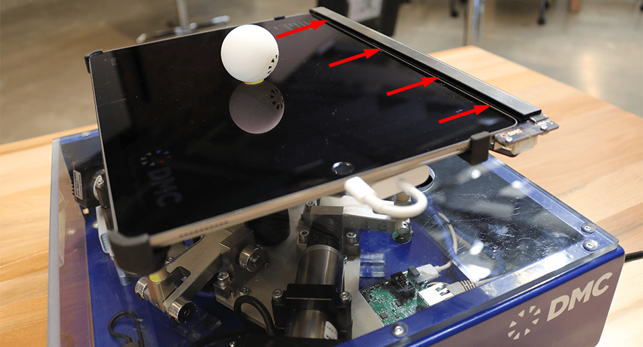 Red arrows point to the Neonode sensor on the DMC tilt table demo.