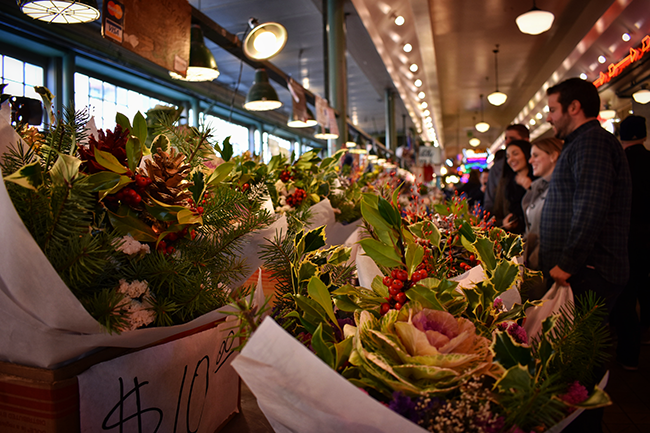 People looking at flowers at Pike Place Market in Seattle