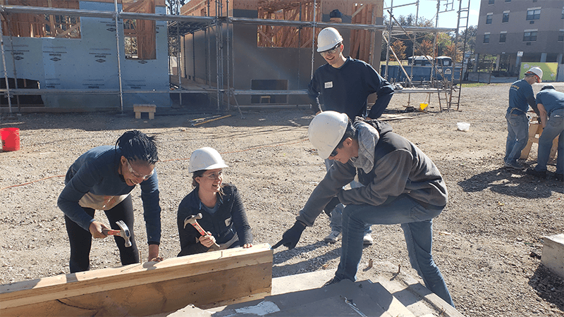 Stephanie and Mary are working on a header for the doorway that they cut and nailed together!