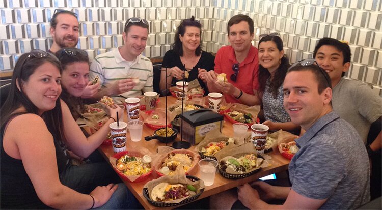 DMC Houston attendees enjoy tacos around a table at Torchy's Tacos.