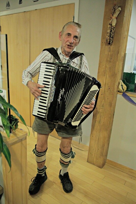 The accordian player performs for DMC employees and guests.