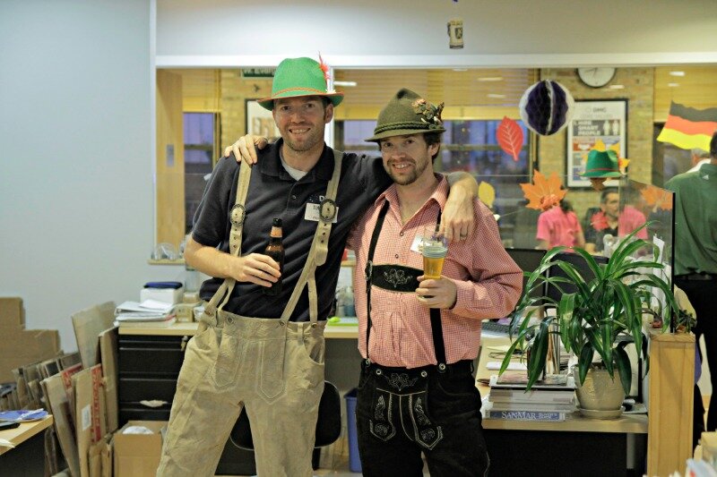 Two engineers pose in their lederhosen at DMC,