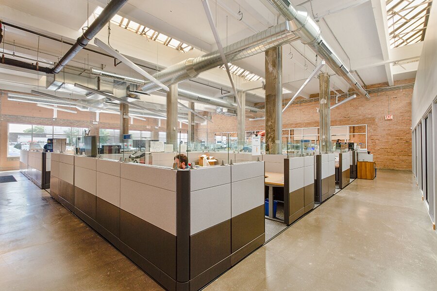 Exposed brick walls, concrete columns, and original skylights at DMC Chicago