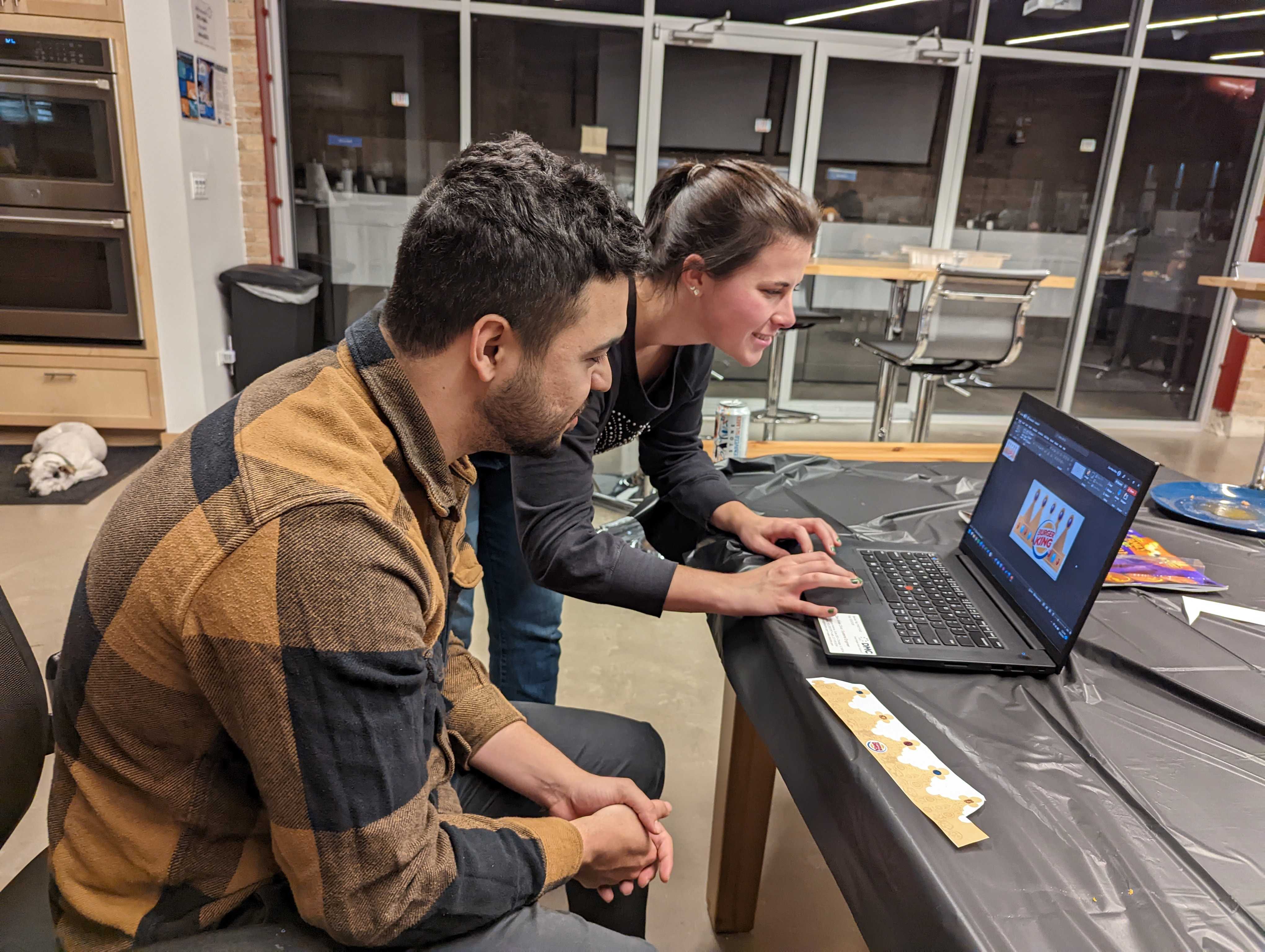 Two people looking at a computer screen