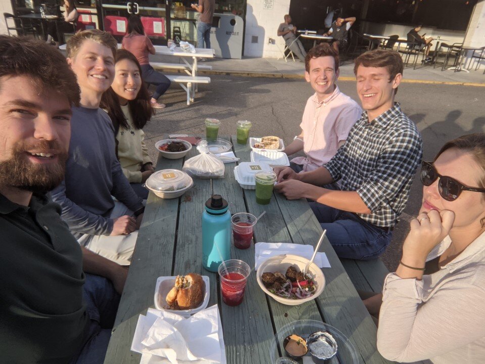 A group of people having dinner on a patio.