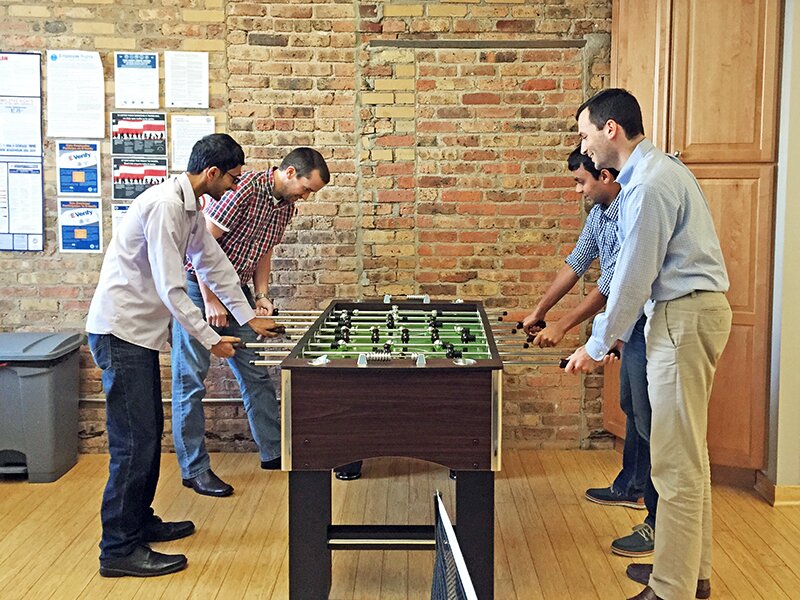 DMC employees play foosball together during a Friday happy hour.