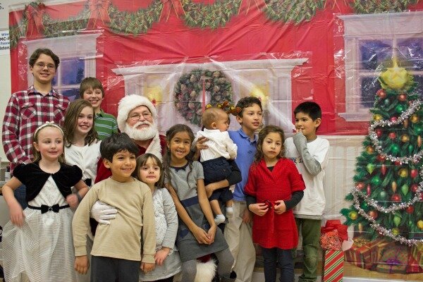 Children of DMC engineers and consultants smile with Santa.