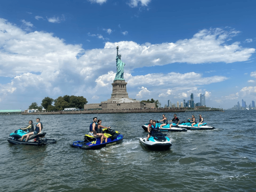 DMC's New York team in boats by the Statue of Liberty