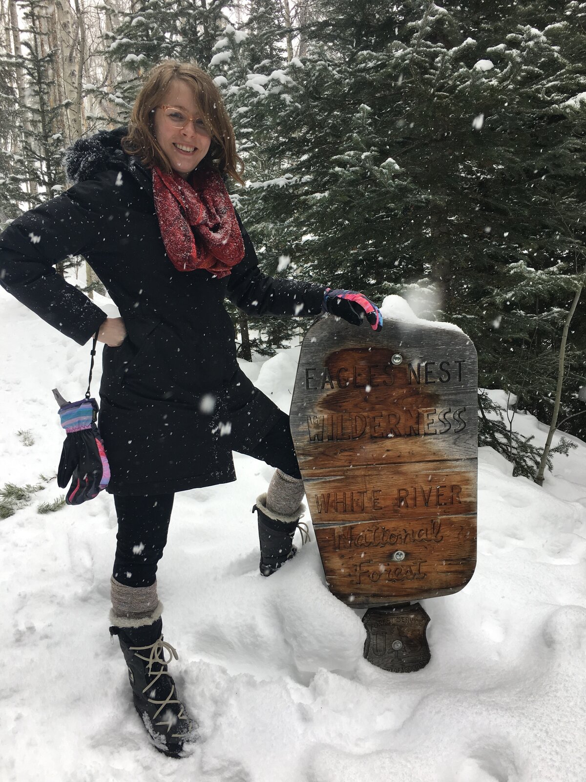 Molly hiking, posing with the Eagles Nest Wilderness sign.