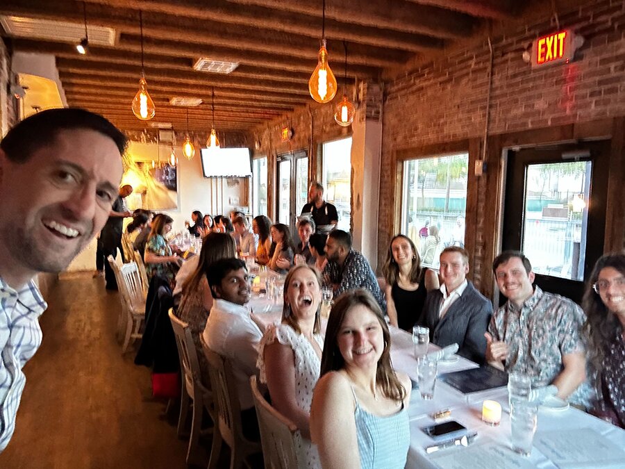 DMC's Houston team seated around a dinner table.