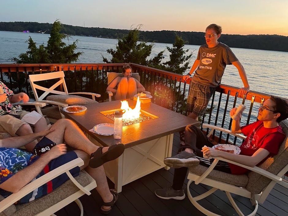 A group of people gathered around a fire pit.