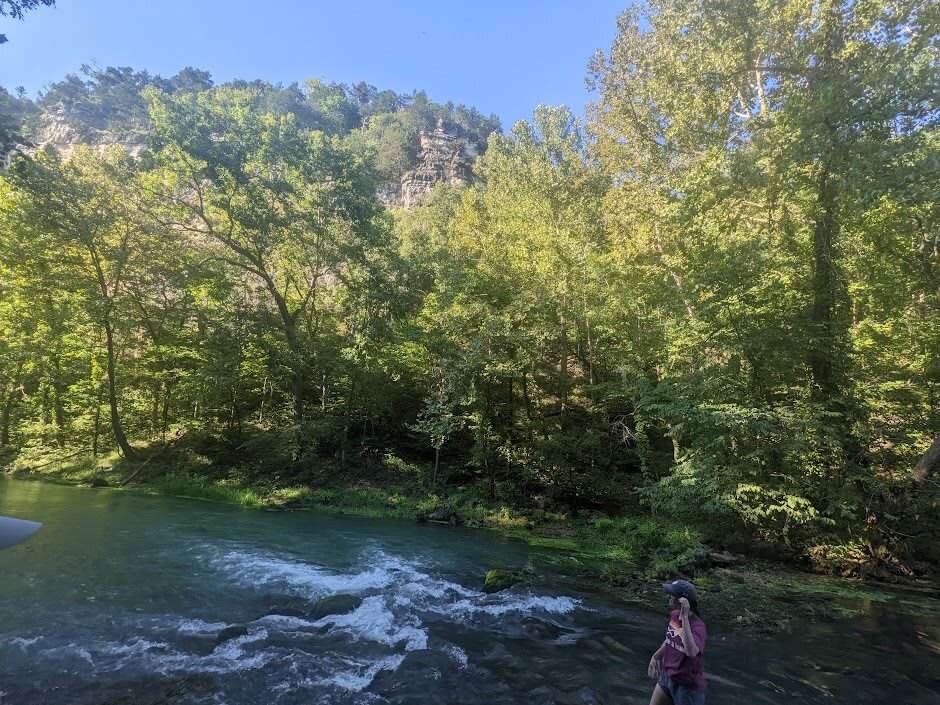 A person standing by a river