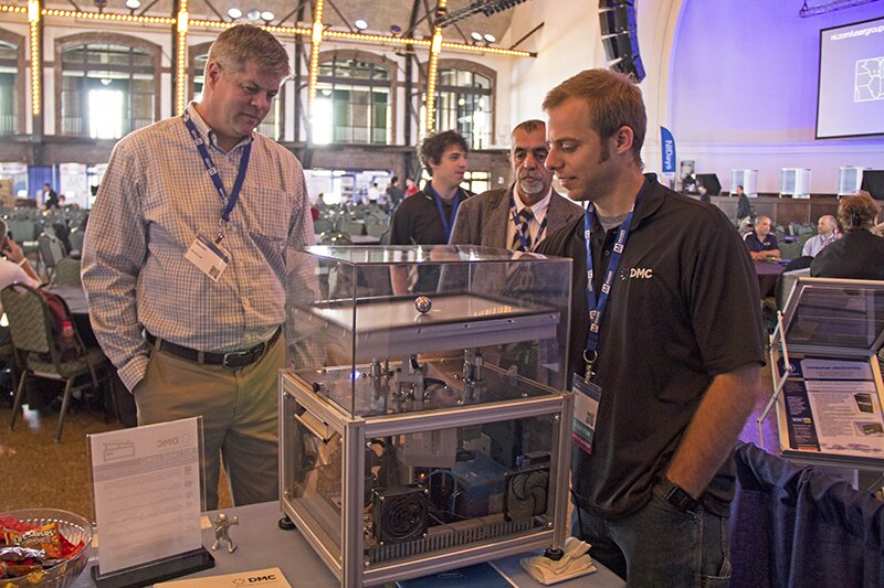 Attendees of NIDays Chicago 2015 view the tilt table demo at DMC's booth