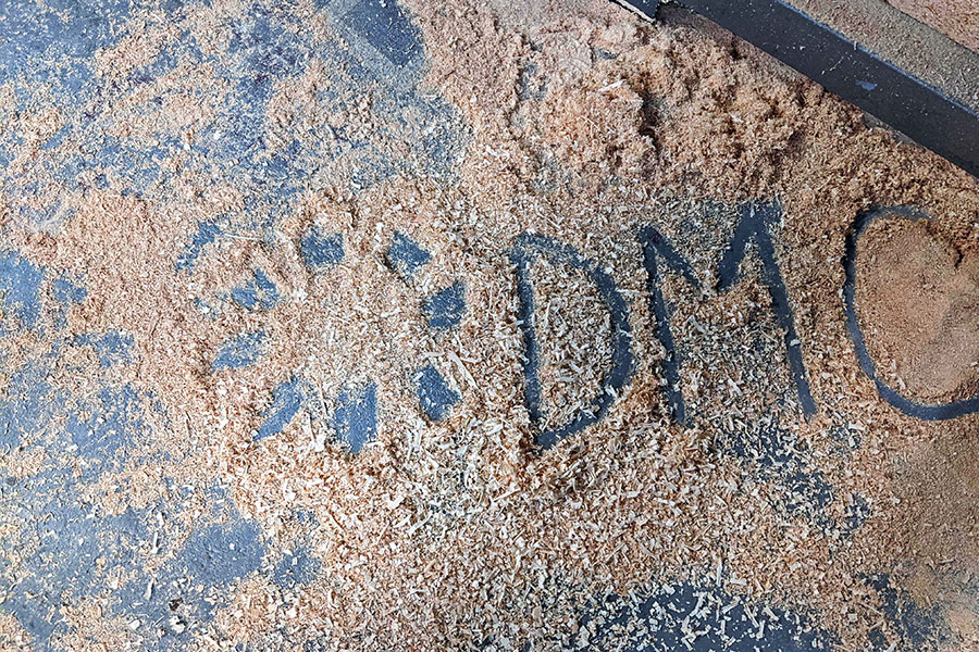 DMC logo in sawdust